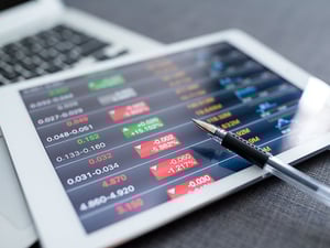 Close up of tablet displaying stocks.