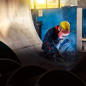 Welder in factory setting. 